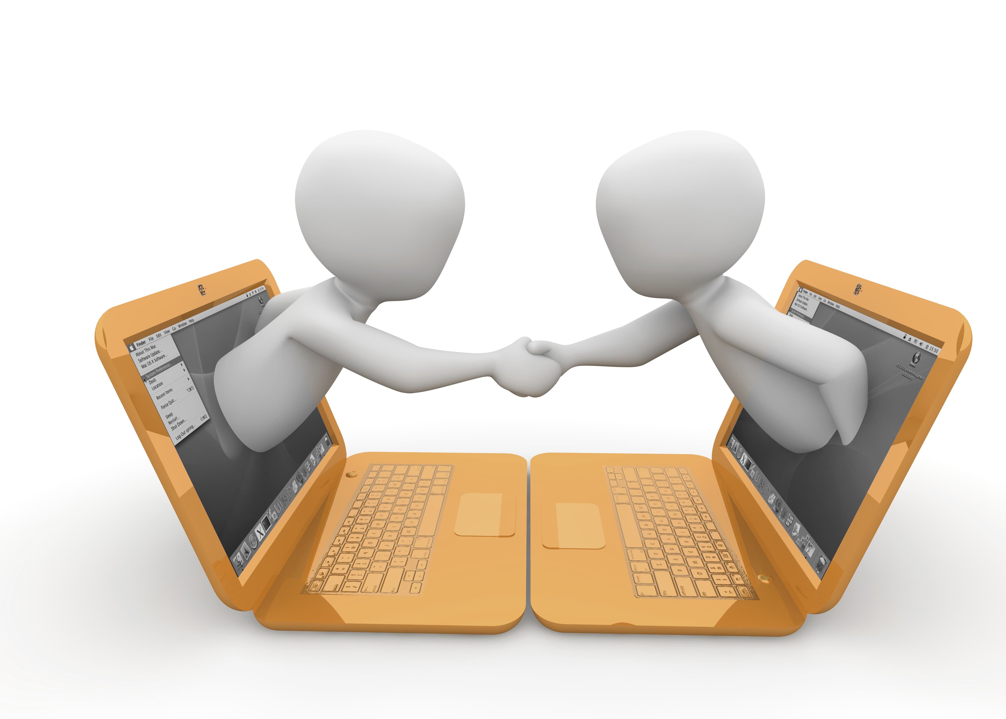 Two people shaking hands through their laptop screens